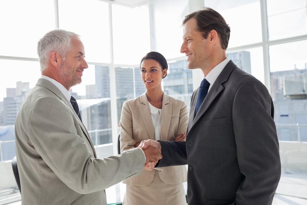 Businesswoman introducing colleagues together in their office